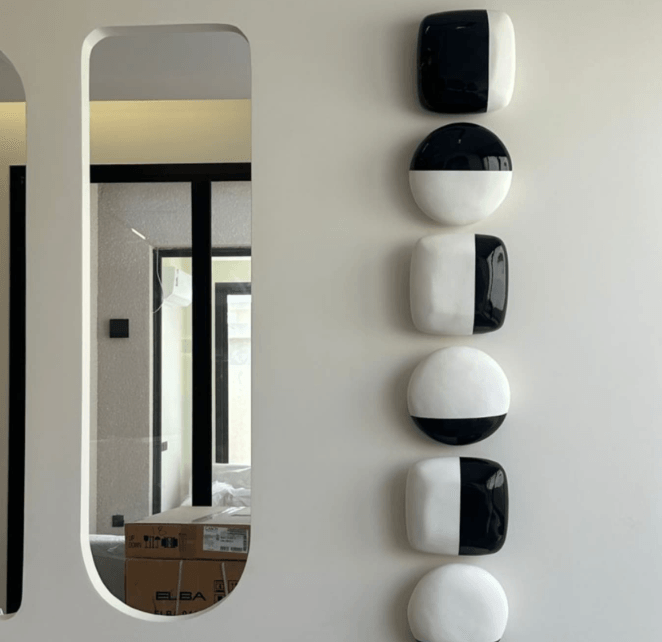 Fiberglass wall pieces installed by a mirror