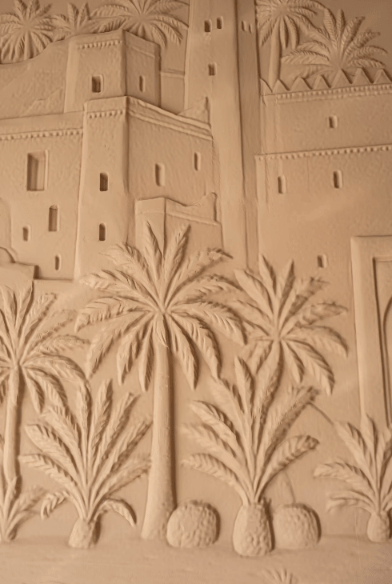 Relief mural detail, palm trees and architecture